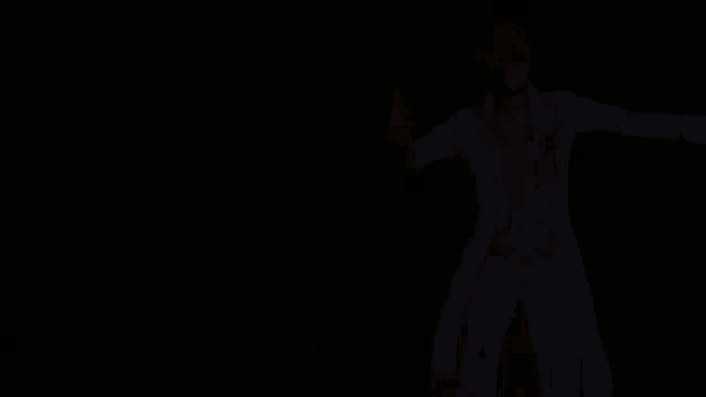 a man in a white suit is standing on a stage and says six
