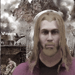 a man with long blonde hair and a beard is standing in front of a tank with smoke coming out of it