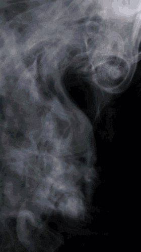 smoke coming out of a person 's mouth against a black background