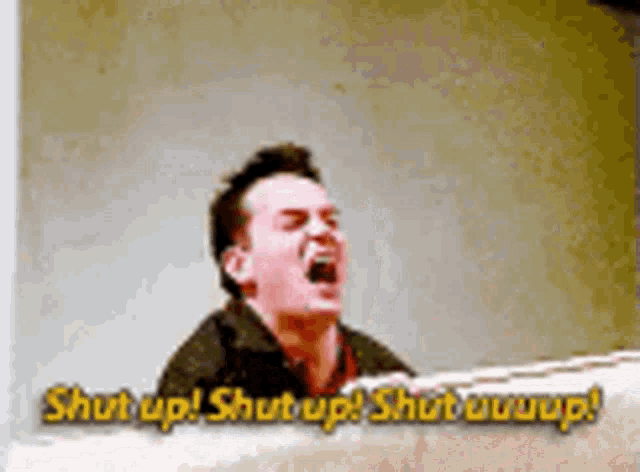 a man is screaming with the words shut up on the bottom