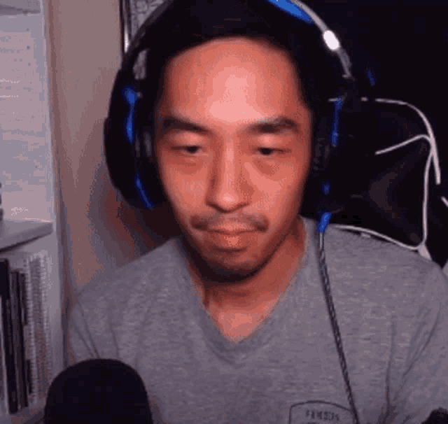 a man wearing headphones and a t-shirt that says famous
