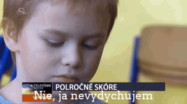 a young boy looks at something in front of a tv screen that says " polrocne skore nie ja nevydychujem "