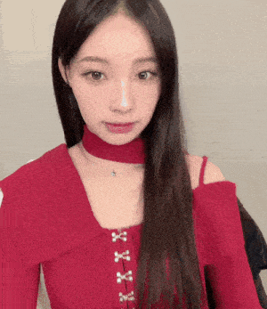 a woman with long hair is wearing a red sweater and a red choker