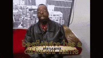 a man in a leather jacket says beetlejuice has a different name in yellow letters
