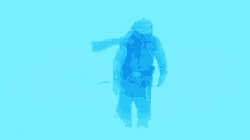 a man in a blue suit is standing in the snow .