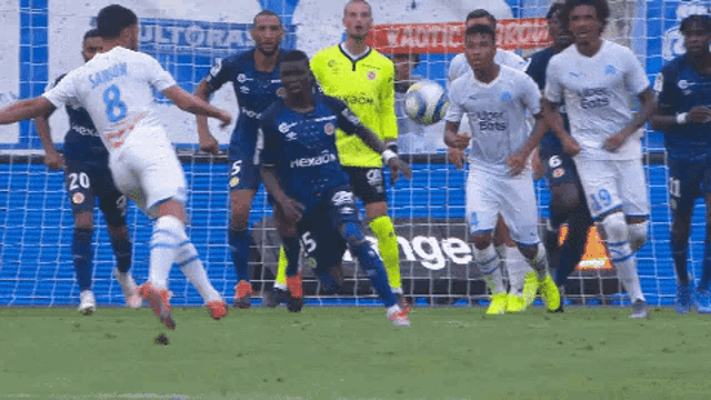 a soccer player with the number 8 on his jersey kicks a ball