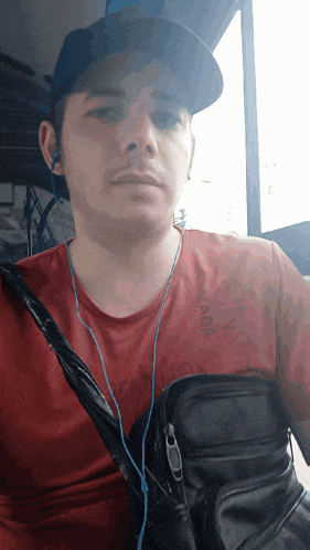 a man wearing a hat and a red shirt that says canada