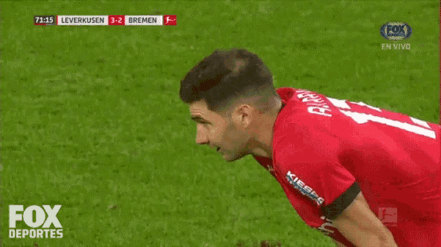 a soccer player in a red jersey with the number 1 on the back