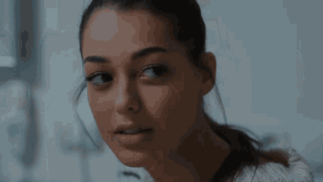 a close up of a woman looking at the camera