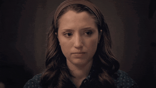 a woman with a headband on her head is looking down
