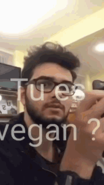 a man with glasses and a beard is asking if he 's vegan