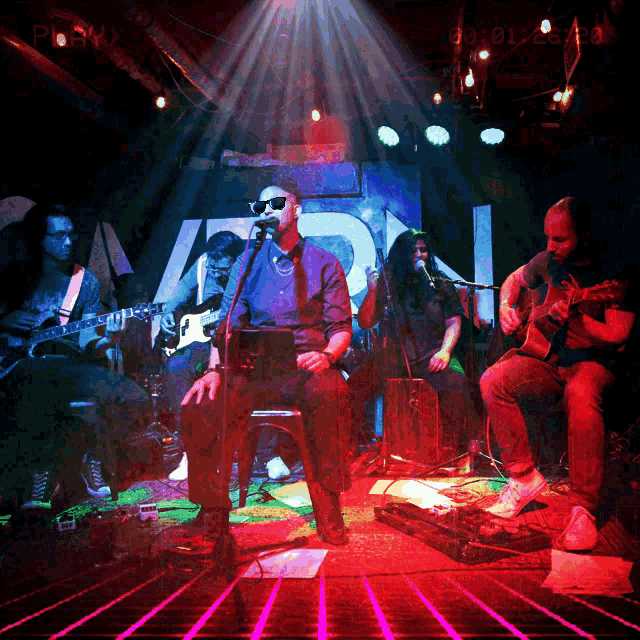 a man singing into a microphone in front of a sign that says ' aion ' on it