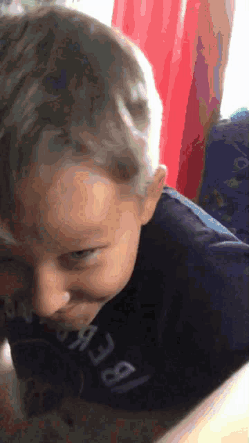 a young boy wearing a shirt that says ' a38 ' on it