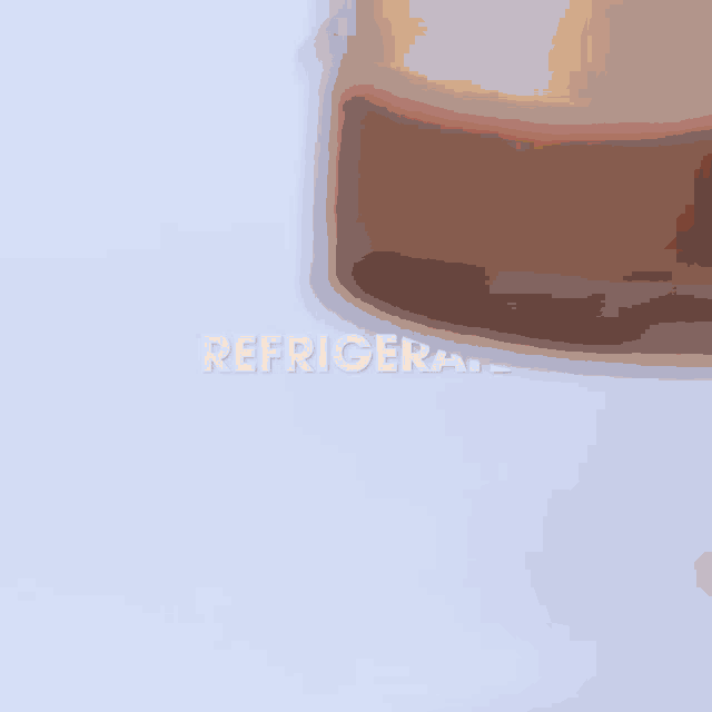 a person is holding a chocolate bar over a dessert in a glass