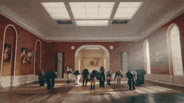 a group of people are standing in a large room with a painting on the wall