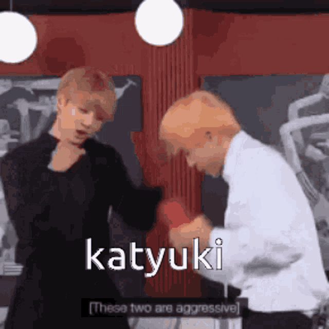 two men are standing next to each other and one of them is saying katyuki these two are aggressive