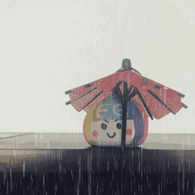 a colorful toy with a red umbrella and the letters ec on it