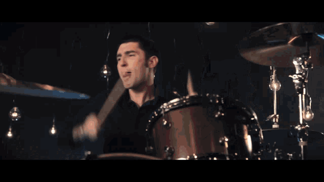 a man is playing a drum set with a cymbal that says zildjian