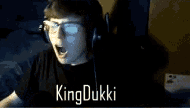 a man wearing headphones with the name king dukki written on the bottom