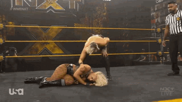 two women are wrestling in a ring with a referee and the word usa on the bottom