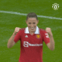 a woman wearing a red teamview jersey is covering her face