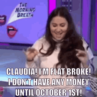 a woman is sitting at a table with a sign that says claudia i 'm flat broke