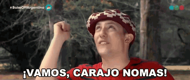 a man wearing a red shirt and a hat says " vamos carajo nomas "