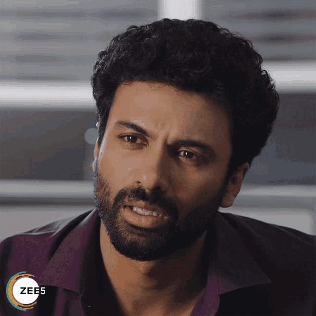 a man with a beard and a shirt that says zee5 on the bottom