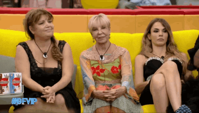 three women are sitting on a yellow couch with the hashtag #gfvip