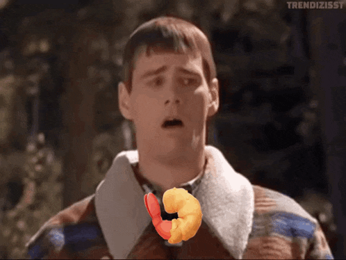 a man in a plaid jacket with a shrimp in his mouth and the words trendizisst on the bottom right