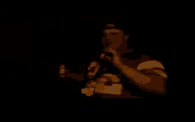 a man wearing a jersey with the number 20 on it is holding a bottle of beer .