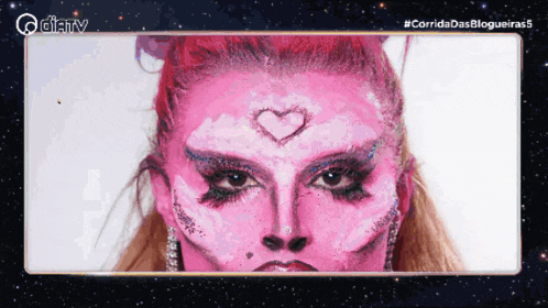 a woman with pink face paint has a heart drawn on her face
