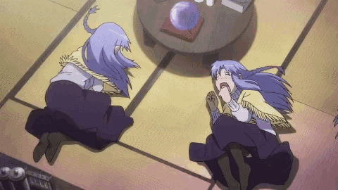 a couple of anime characters laying on the floor with one yawning