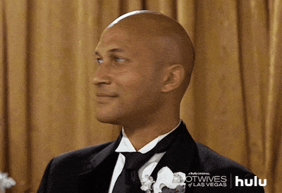 a bald man in a tuxedo with a hulu logo in the corner