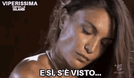 a close up of a woman 's face with the words viperissima temptation island in the background