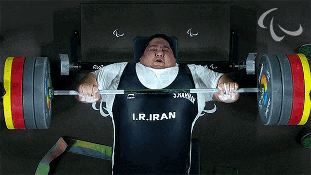a man lifting a barbell with a shirt that says i.r.iran on it
