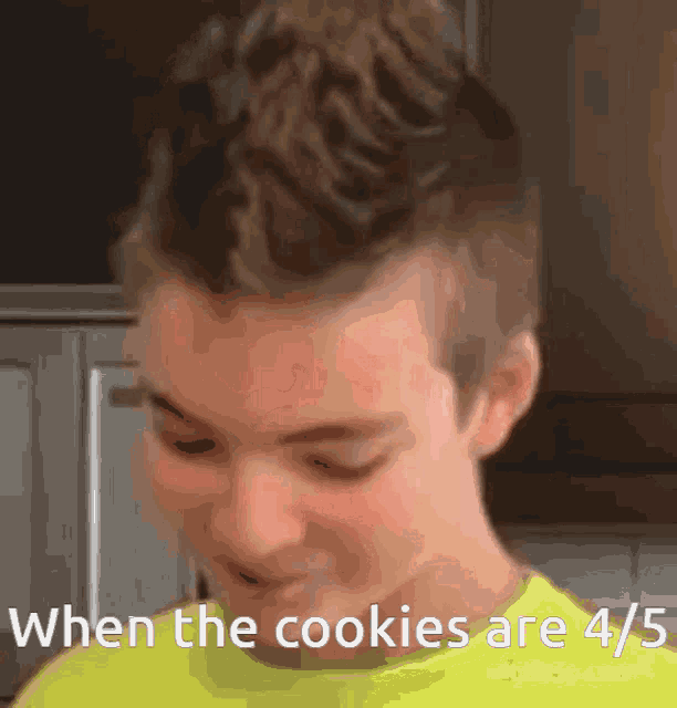 a boy with a mohawk says when the cookies are 4/5 in a yellow shirt