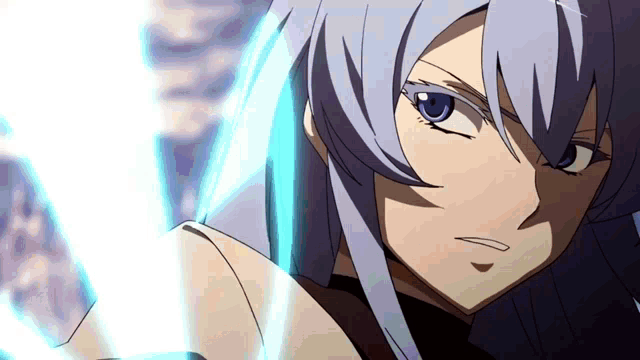 a close up of a person 's face with blue eyes and gray hair