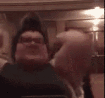 a blurry picture of a man with his arm up in the air .