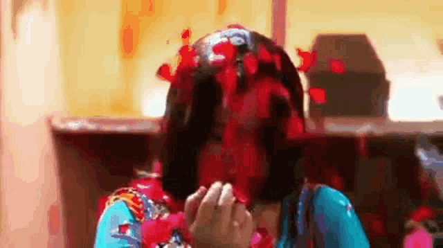 a woman with blood on her face is holding a rose .