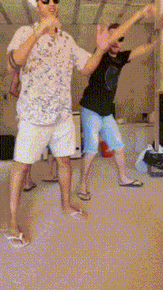a group of men are dancing together in a room