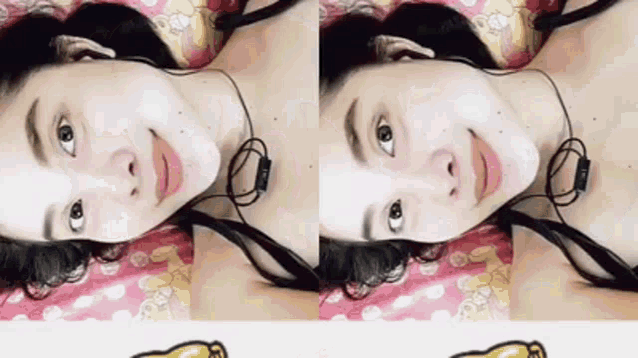 a woman wearing headphones is laying on a bed