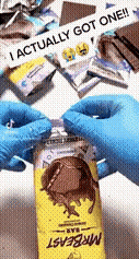 a person wearing blue gloves is opening a bottle of mrbeast