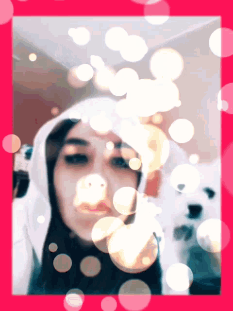 a woman in a white hoodie is in a pink frame