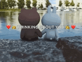 a brown bear and a white rabbit are holding hands in front of a body of water with the words thinking about you above them