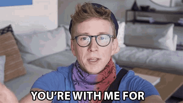 a man with glasses and a scarf says you 're with me for