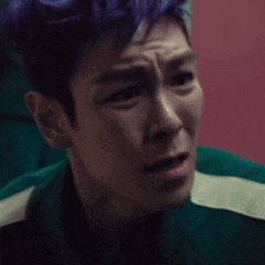 a close up of a man 's face with a slight smirk on his face