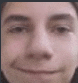 a close up of a person 's face with a smiling face .