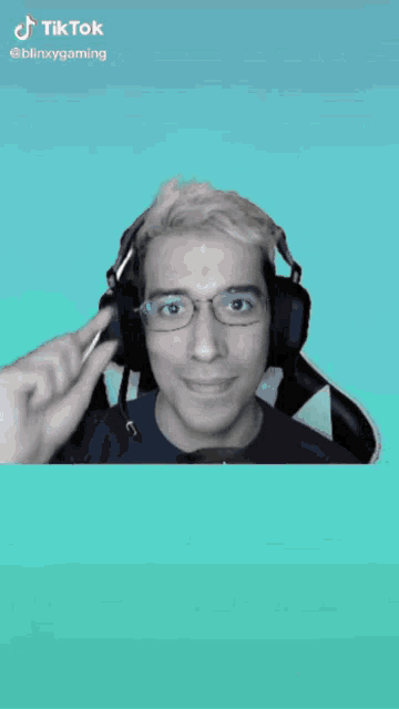 a man wearing glasses and headphones has a tiktok watermark on the bottom right