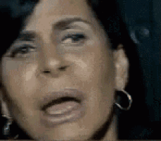 a close up of a woman 's face with her mouth open .